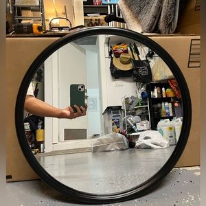 Round black trimmed mirror